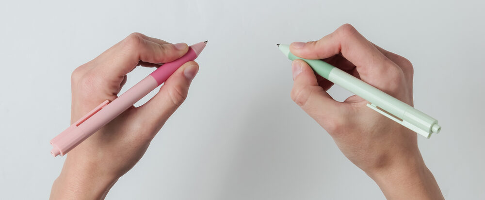 Ambidextr.,Female,Hands,Hold,Pens,And,Write,On,White,Background.