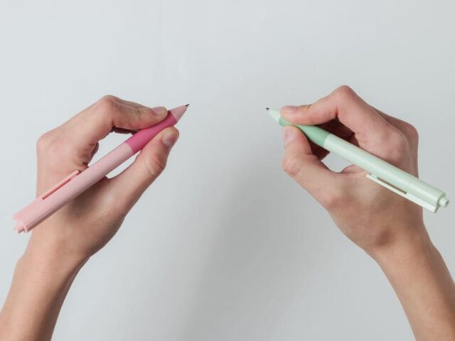 Ambidextr.,Female,Hands,Hold,Pens,And,Write,On,White,Background.