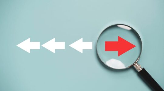 Red,Arrow,Inside,Of,Magnifier,Glass,And,Different,Direction,From