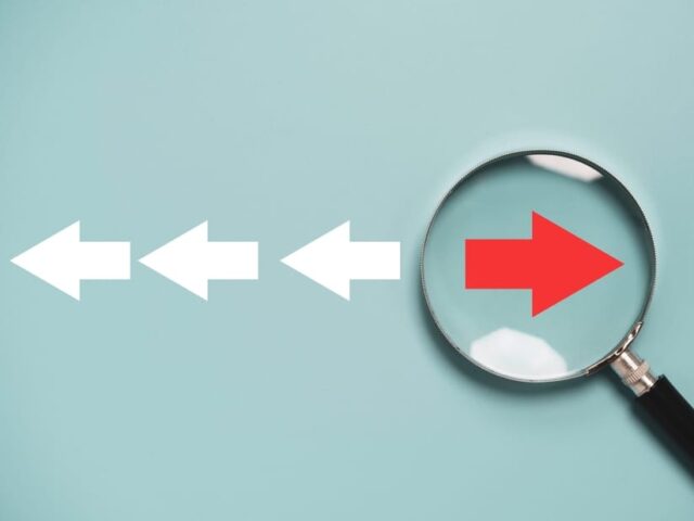 Red,Arrow,Inside,Of,Magnifier,Glass,And,Different,Direction,From