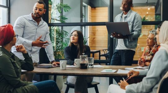 Creative,Business,Professionals,Having,A,Group,Discussion,During,A,Meeting