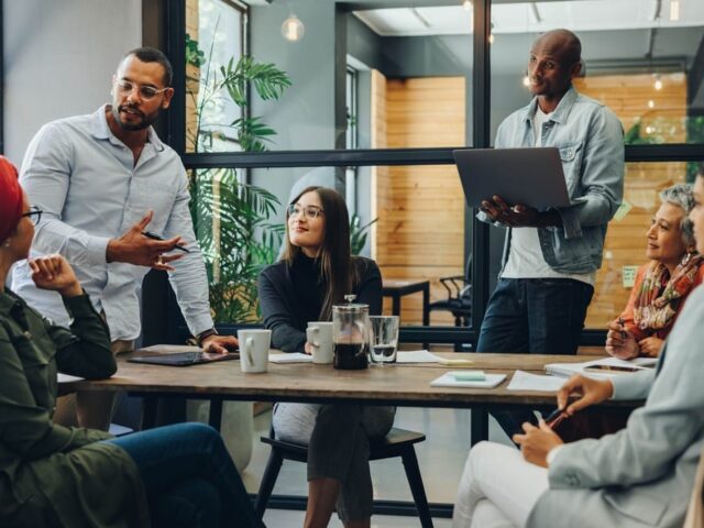 Creative,Business,Professionals,Having,A,Group,Discussion,During,A,Meeting