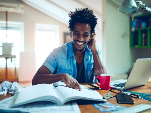 Young,Man,Of,African,Ethnicity,Studying,And,Using,The,Laptop