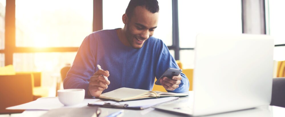 Cheerful,Attractive,Afro,American,Male,Freelancer,Chatting,With,Friends,In