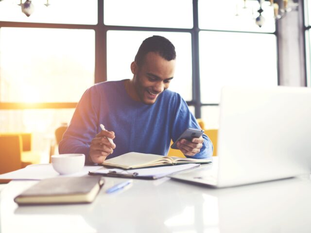 Cheerful,Attractive,Afro,American,Male,Freelancer,Chatting,With,Friends,In
