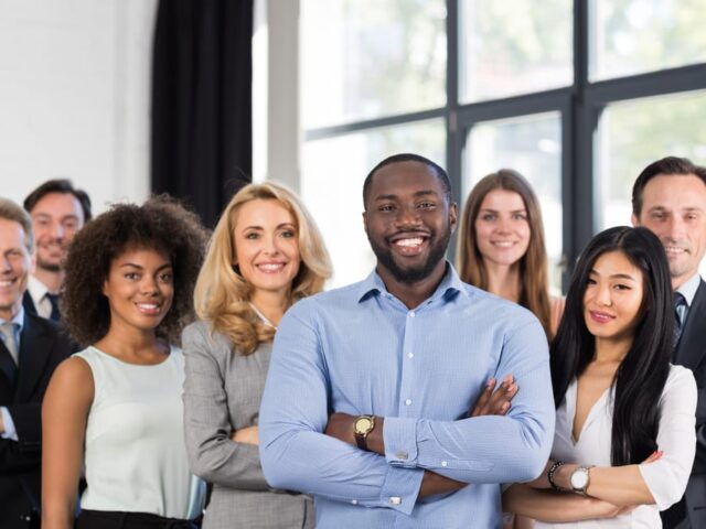 African,American,Businessman,Boss,With,Group,Of,Business,People,In